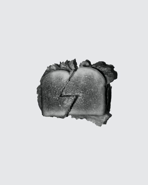 Black and white BLT sandwich against solid background