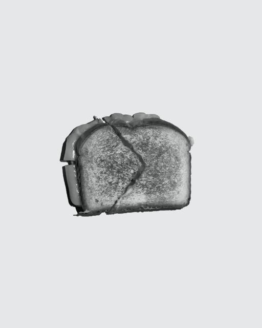 Black and white grilled cheese sandwich against solid background