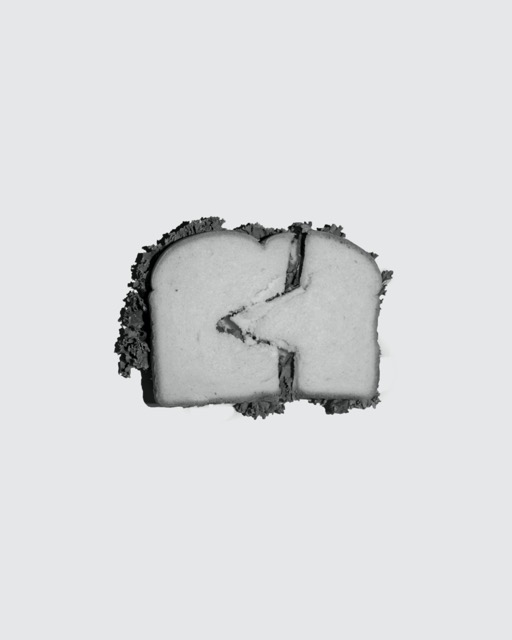 Black and white sandwich cut unevenly on solid background